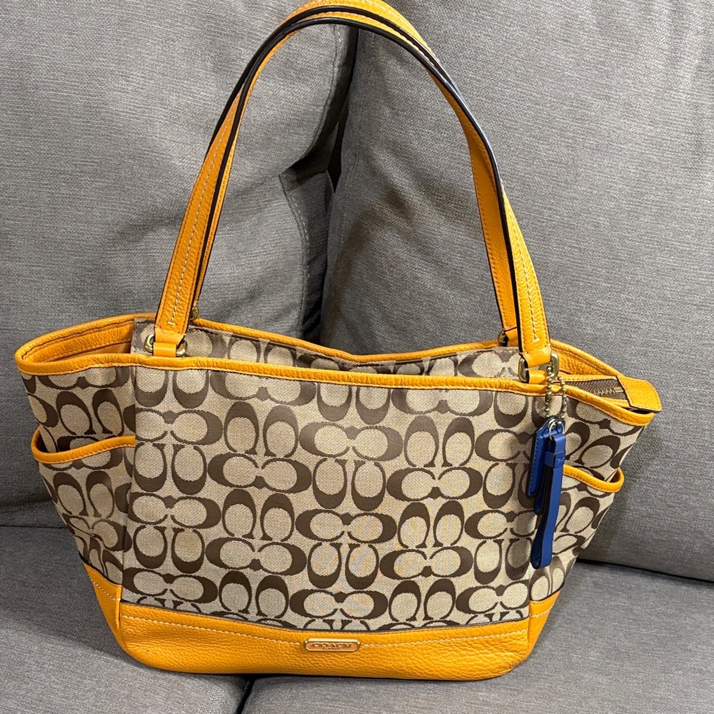 Coach Beige Signature Canvas Tote with Yellow Trim and Blue Charm